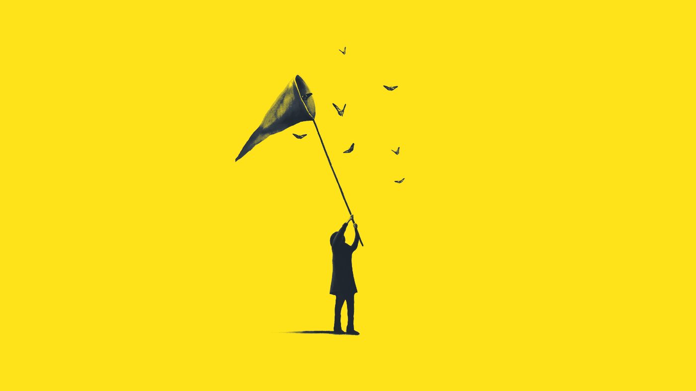 A figure holding up a net as birds escape from it into an open yellow sky — the decision to let something go.